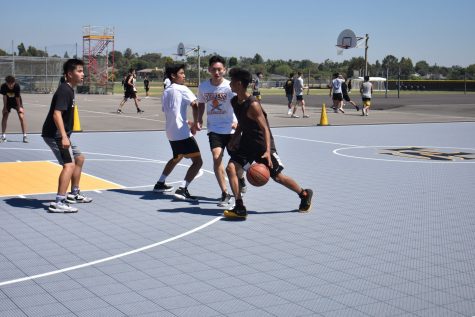 Junior Krystofer Bagunu dribbles past senior Peter Park during practice Aug. 14. Photo taken by Accolade photographer Paul Yasutake.