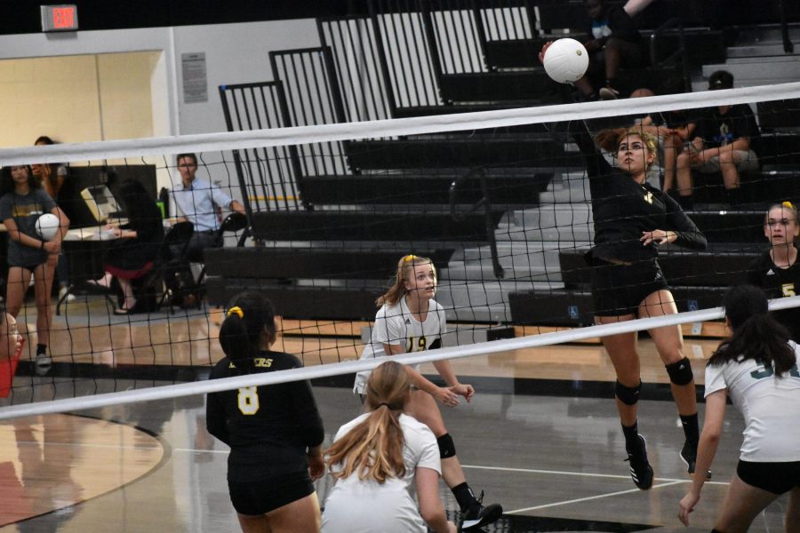 Middle blocker senior Marlena Martinez (right) jumps in the air to spike a ball during a 3-0 win against Bonita High School Sept. 10 at the Sunny Hills gym. Photo taken by Accolade photographer Paul Yasutake.