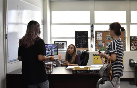 College and Career Center’s guidance and counseling technician Evelyn Casillas (center) helps a student and parent gain information on the college application process. (Photo by Accolade photo editor Megan Shin)