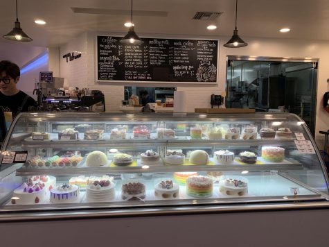 Cafe Mak displays their cakes in a glass display case and presents their other menu items on a black chalkboard. Photo taken by Megan Shin.
