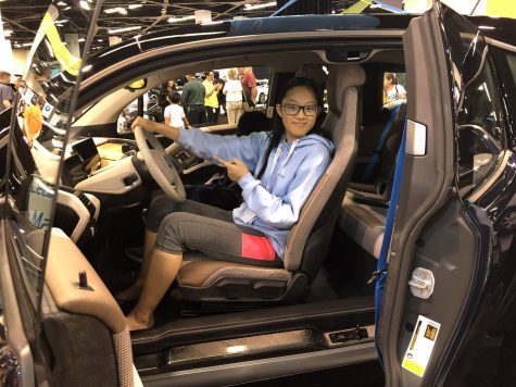 Accolade staff writer Hope Li sits in a 2018 BMW i3 Oct. 3 at the Orange County Auto Show at the Anaheim Convention Center. Photo taken by Accolade adviser Tommy Li