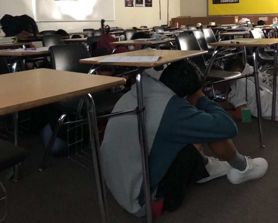 Freshman English teacher Jennifer Kims students hide under their desks in Room 188 after hearing about the lockdown announcement during second period Oct. 24. Image posted with permission from Jennifer Kim