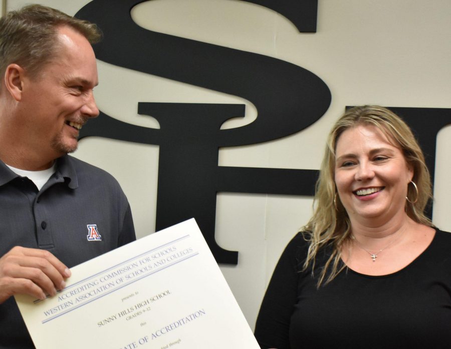 Principal Allen Whitten (left) shows the WASC certificate to English teacher Suzanne Boxdorfer, who was the WASC coordinator in charge of producing a self-study report for the visiting team in March of last semester. The document concluded that  Sunny Hills High Schools accreditation is valid until June 30, 2025. Photo by Accolade photographer Paul Yasutake