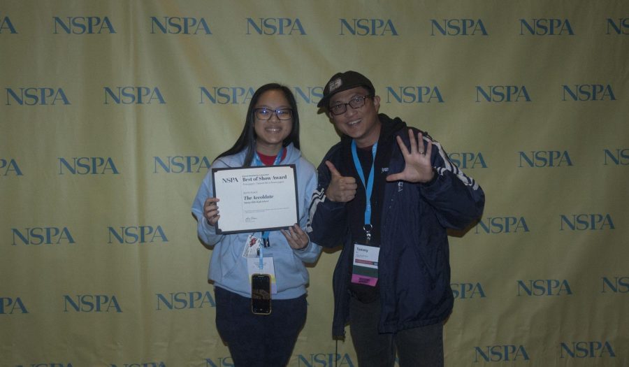 Accolade staff writer junior Hope Li (left) holds the Best of Show certificate from the National Scholastic Press Association while adviser Tommy Li holds up six fingers signifying the placement. The Nov. 23 awards ceremony was held in Washington, D.C., and The Accolade's first issue of the school year earned recognition for placing in the Top 10 nationally.