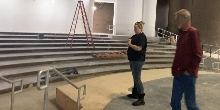 Theater teacher Amanda Gieser (left) and the site construction project manager survey the new stage extension during a recent inspection of the PAC, which has been closed since May for remodeling. Posted with permission from Melissa Stinson.