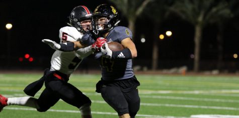 Running back senior Jun Ahn breaks a tackle from a Troy defender during one of his first quarter runs. Ahn ended the game as the leading scorer with four touchdowns and 164 total rushing yards in the 48-16 victory Nov. 1 at Buena Park High School stadium. Photo taken by Accolade photographer Paul Yasutake
