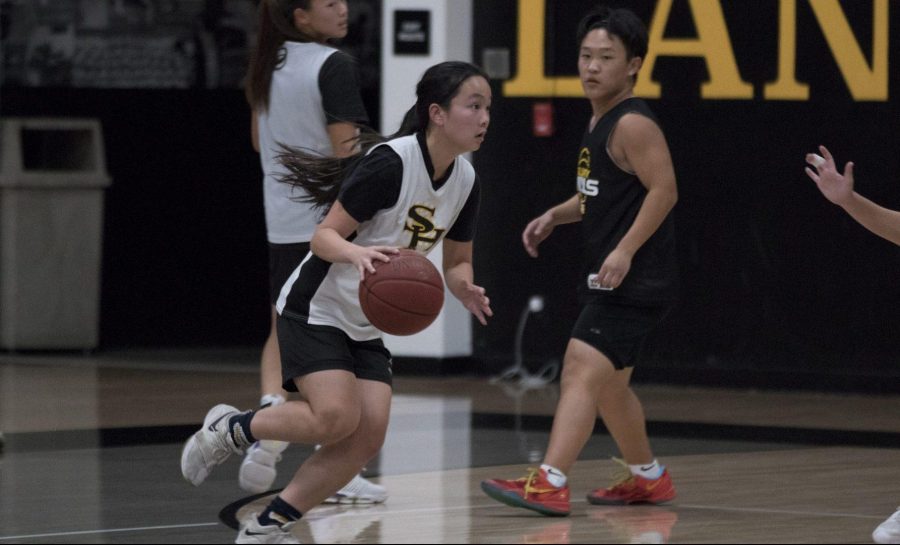 Shooting guard and small forward senior Rachel Kim drives into the lane while in a scrimmage against team assistants and other girls basketball players at the Sunny Hills gym Nov. 14. Photo taken by Accolade photographer Paul Yasutake