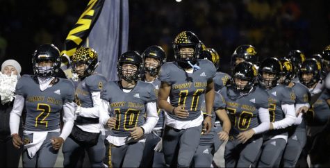 Wide receiver and defensive back senior WIlson Cal (center) leads the team onto the field before the Lancers' 24-21 win in the CIF-Southern Section Division 8 championship game at San Marcos High School Stadium Nov. 30. Cal intercepted a pass in the Sunny Hills endzone to seal the victory with 30 seconds left in the game. Photo taken by Accolade photographer Paul Yasutake
