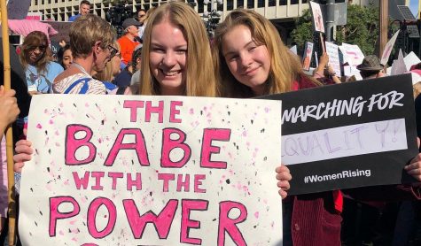 Youth Empower Club member senior Taylor Michel (left) holds up one of the signs she made for the Jan. 18 Women's March in downtown Los Angeles, while her sister, freshman Jaden Michel, shows one of the placards that a demonstrator gave her. Image posted with permission from Angelica Mosqueda.