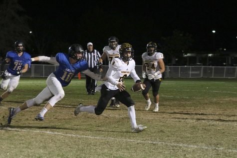 Quarterback and defensive back senior Luke Duxbury escapes from a Bakersfield Christian defender during the CIF State SoCal Regional Division 3-A game Dec. 7 at Bakersfield Christian High School stadium. Photo taken by Accolade photographer Paul Yasutake