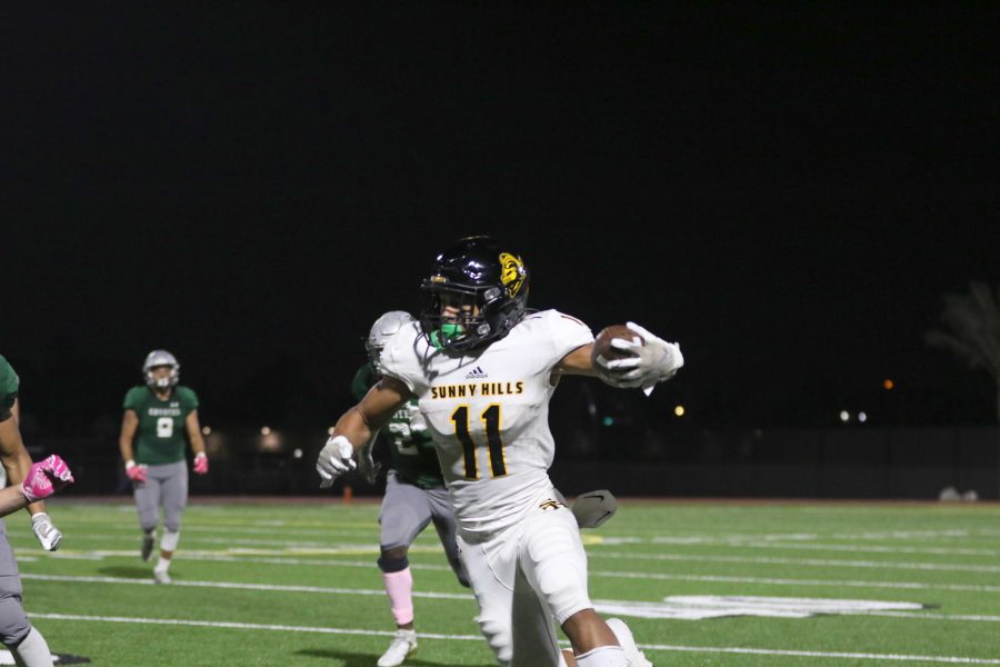 Wide receiver and defensive back senior Wilson Cal runs an interception back during a 49-8 win against Buena Park Oct. 11 at Buena Park High School stadium. Photo taken by Accolade photographer Paul Yasutake