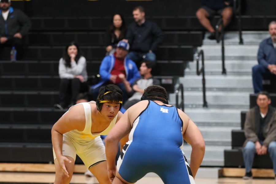 Senior Andrew Park (left) stares down Juan Sanabria during their 220-pound weight class bout Jan. 15 in the Sunny Hills gym. Park pinned Sanabria in the second period to put the Lancers ahead 41-15 with just four matches remaining. Photo taken by Accolade photographer Paul Yasutake