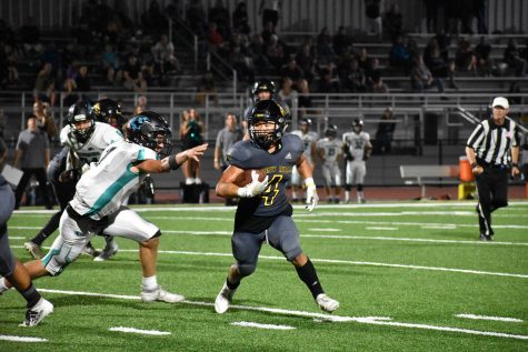 Running back and defensive back senior Jun Ahn carries the football in the red zone during the season opener against Aliso Niguel Aug. 30 at Buena Park High School stadium. Ahn has committed to playing Division 1 football at Drake University in Des Moines, Iowa, where he will major in kinesiology. Photo taken by Accolade photographer Paul Yasutake
