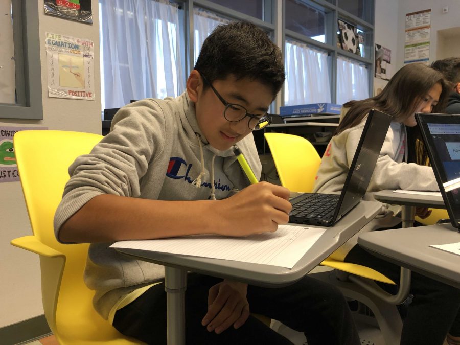 Eighth-grader Kyle Pak works on one of his zero period Algebra 2 Honors assignments in math teacher Nicole Knutsons class. Pak and two other Parks students take biology class at Sunny Hills as well. Photo take by Accolade staff writer Alice Shin.