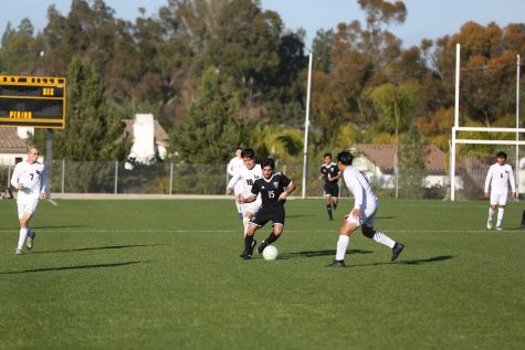 Midfielder senior Brandon Toledo (center) dribbles through a pair of Laguna Hills defenders during Sunny Hills' 2-1 victory over Laguna Hills Feb. 12 at the Sunny Hills field. Photo taken by Accolade photographer Paul Yasutake