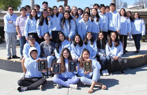 The Accolade's web editor senior Alex Park (left, front row), editor-in-chief senior Michelle Buckley and managing editor senior Hannah Yi hold up Orange County Journalism Education Association Best of Show plaques that have been awarded to the newspaper for the past four years as part of an annual writeoff contest. Image used with permission from Arya Patel.