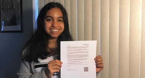 Senior Dana Mabin holds up the email she received April 7 from the Orange County Community Foundation notifying her of the $25,000 scholarship she received from a county AVID awards ceremony, which was canceled and turned into a virtual slide presentation ceremony because of the COVID-19 pandemic. According to the email, Mabin will be given $6,250 through a scholarship check which will be mailed directly to her educational institution to help cover each year’s college tuition up to four years total.