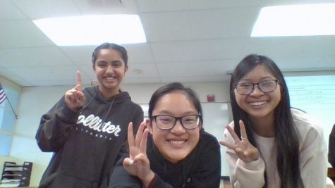 Junior Hope Li (center) gets her friends in her sixth period Honors Chemistry class to hold up their fingers to signify the number 133 on the 133rd day of school March 13, in Room 112. Li started collecting images of a tally of each day of the school year as a time capsule project at the start of the 2019-2020 school year. Despite school closure because of the coronavirus pandemic announced that day, she has continued with it through the last day of the spring semester.