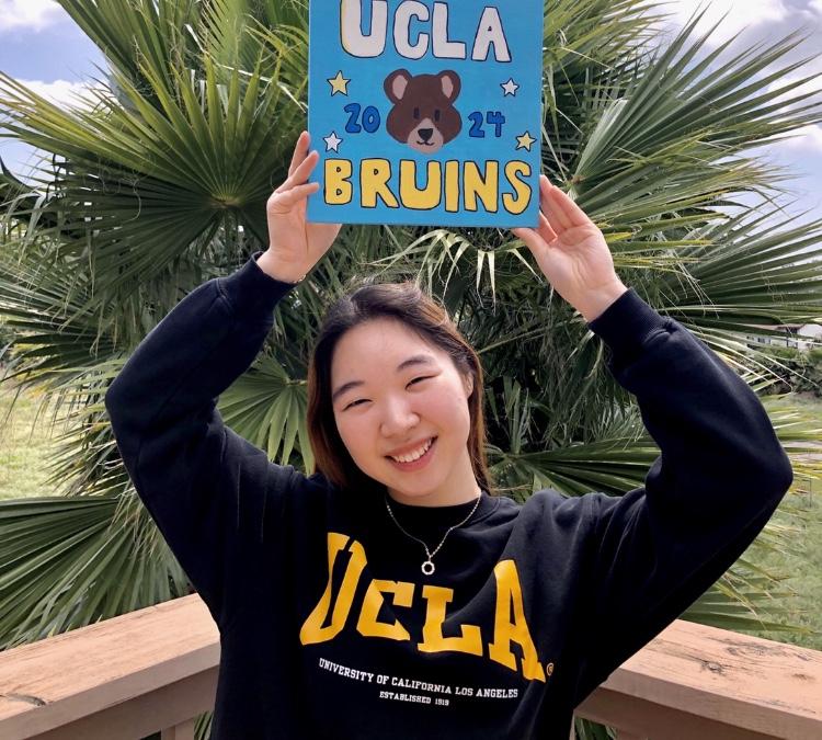 Senior Stacy Kim graduates as one of the 12 valedictorians for the class of 2020 at her house wearing UCLA merch. Photo reprinted with permission from Stacy Kim