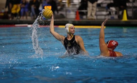 Kaya Hart (center) prepares to take a shot during a 16-5 victory over Fullerton at the Troy High School pool on Jan. 22.
