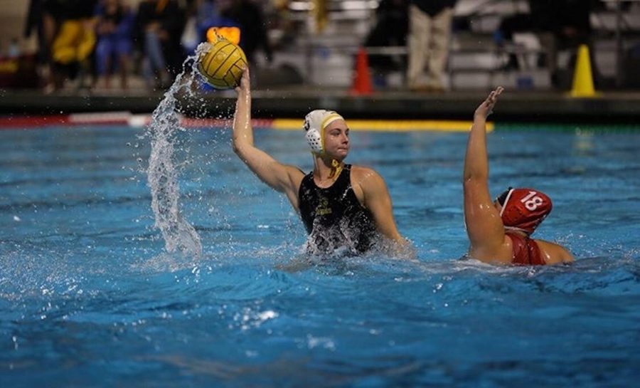 Kaya Hart (center) prepares to take a shot during a 16-5 victory over Fullerton at the Troy High School pool on Jan. 22. 