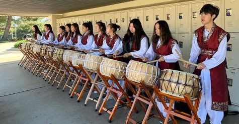 Wearing their performance outfits, some members of the Korean Culture Club practice with their buk drums March 2 after school on campus for Korean Culture Night. The March 21 event, which would have commemorated its 10th year, was canceled a week before because of the spread of the novel coronavirus. The thunderous sounds created by these instruments represent the South Korean nation, and the drummers' performance would have been the first one after intermission. Image posted with permission from Esther Lee.