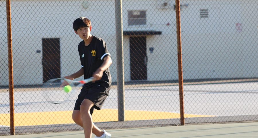 Boys tennis player rising sophomore Jaden Han returns the ball to his opponent in a March 3 match against Whitney. With the new CIF bylaw modifications, athletes will have the opportunity to participate in outside club activities and events during the regular school sports season. 