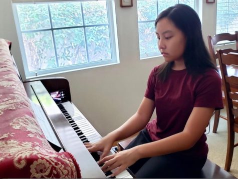 With her iPhone placed on the far right end of her piano set for video recording, sophomore Lauren Pak starts her practice session Aug. 19 from her Fullerton home, playing a composition titled, “Promise of the World,” from the Japanese anime, “Howl’s Moving Castle.” Pak will eventually record the final version as a trio with two other student volunteers as part of the Harmony4Homes community service project that she started in the summer to send video music performances to the elderly in local and national nursing homes.