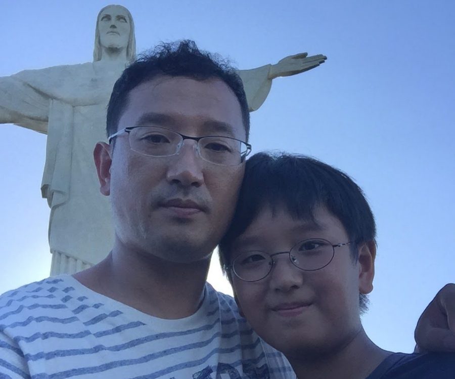 Junior Edward Cho (right), who will attend Sunny Hills virtually this year from his home in São Paulo, Brazil, stands with his father in 2015 in Rio de Janeiro, Brazil.