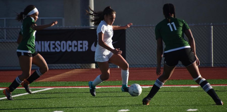 Then-freshman Brianna Figueroa (center) tries to dribble the ball away from two Long Beach Poly High School defenders during the Feb. 16, 2019, California Interscholastic Federation semifinal playoff game at Wilson High School in Long Beach. The junior forward will be among the players returning from that title-winning squad for the 2020-2021 season, which will also include open tryouts for new additions to the team.