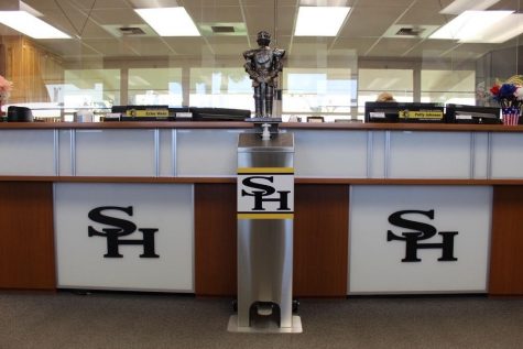 The Winston the Lancer statue sits above the touch-free sanitizing unit placed in the main office in Room 3. Custodians have placed one touch-free sanitizing unit identical to this one in every single classroom for students to utilize as they enter or leave.