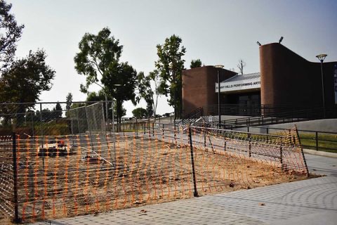 The area in front of the building is enclosed with fences in preparation for the ongoing school construction of the landscaping of the PAC, which will include the installation of a retaining wall.