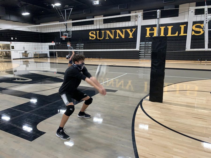 Junior Sebastian Bonca (front) sets the volleyball while practicing his receives during a Nov. 18 practice in the Sunny Hills gym.