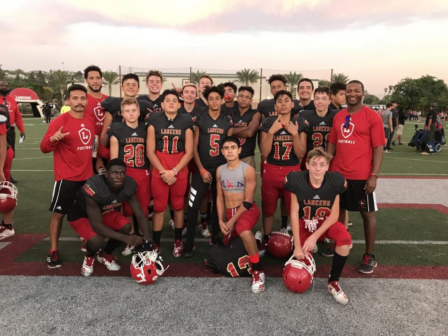 New athletic director Paul Jones (right) stands next to members of the Orange Lutheran freshman football team after a game. Jones held the athletic director position at Orange Lutheran for six years before moving to Sunny Hills.