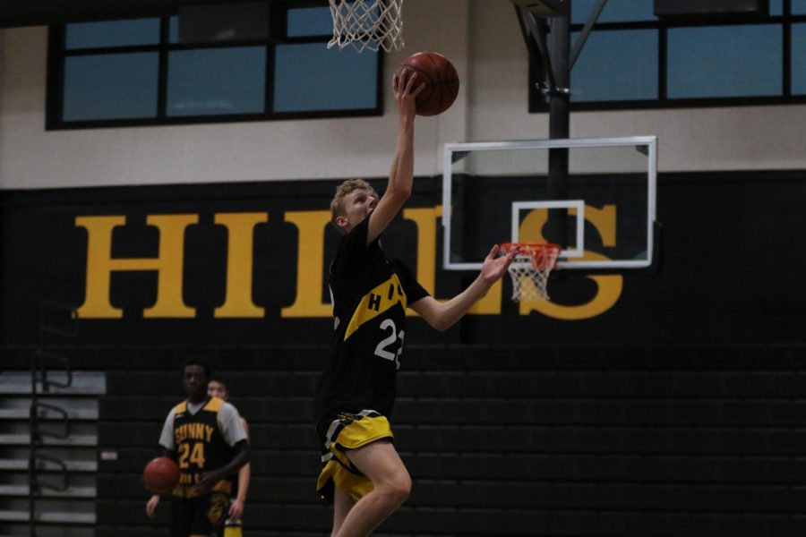 Boys basketball shooting guard senior Caleb Harnett jumps up for a layup in the gym during a Nov. 14, 2019 practice. Tryouts for the boys basketball team are set to be held Feb. 6 at 10 a.m. to 11:30 a.m. on the outdoor sports courts. 