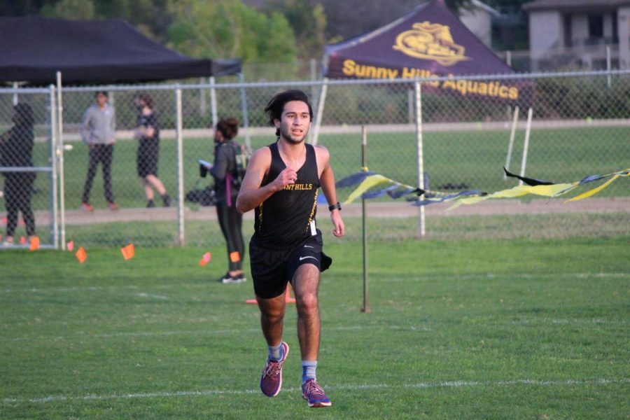 Junior cross country runner Zachary Gomez runs down the last stretch of his 3-mile run. The junior finished 3rd overall with a time of 17:31.