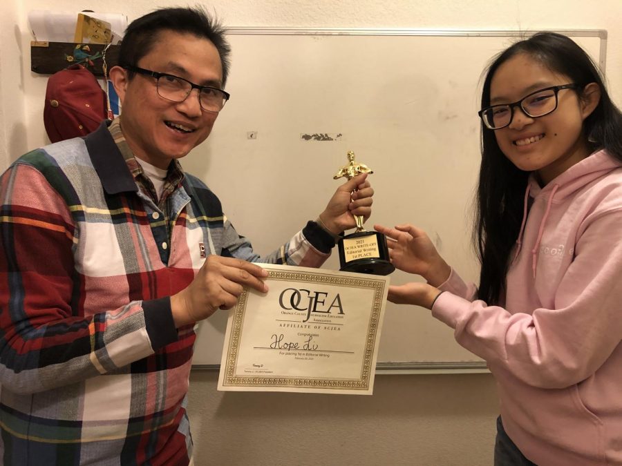 Accolade adviser Tommy Li (left) presents the first-place editorial writing trophy and certificate to Accolade Opinion editor senior Hope Li at their Irvine home Wednesday, March 3, after he picked up the journalism programs awards. The eldest daughter of Tommy Li competed  Saturday, Feb. 20, in the Orange County Journalism Education Association writeoffs contest held virtually over Zoom.