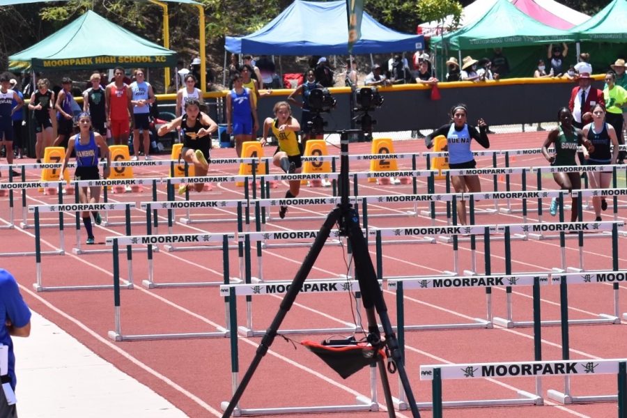 Rising senior Abigail Hahm jumps to victory as she sprints toward the finish line during a 100-meter hurdle event June 5 at Moorpark High School. Hahm placed first in her heat with a personal best of 16.54 advancing to the California Interscholastic Federation Finals June 12.
