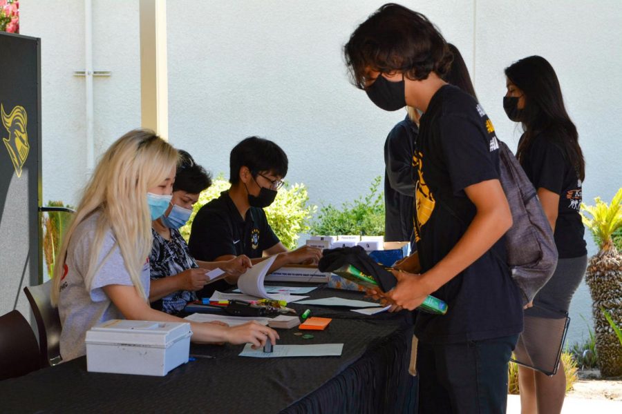 Senior Dominic Siañez (right) checks in with a South Coast Photography staff member at Lancer Day, Tuesday, Aug. 10, to take his ID picture. Despite the continuing spread of COVID-19’s Delta variant, Siañez will be among the nearly 2,500 students who have enrolled at Sunny Hills for live classroom instruction.