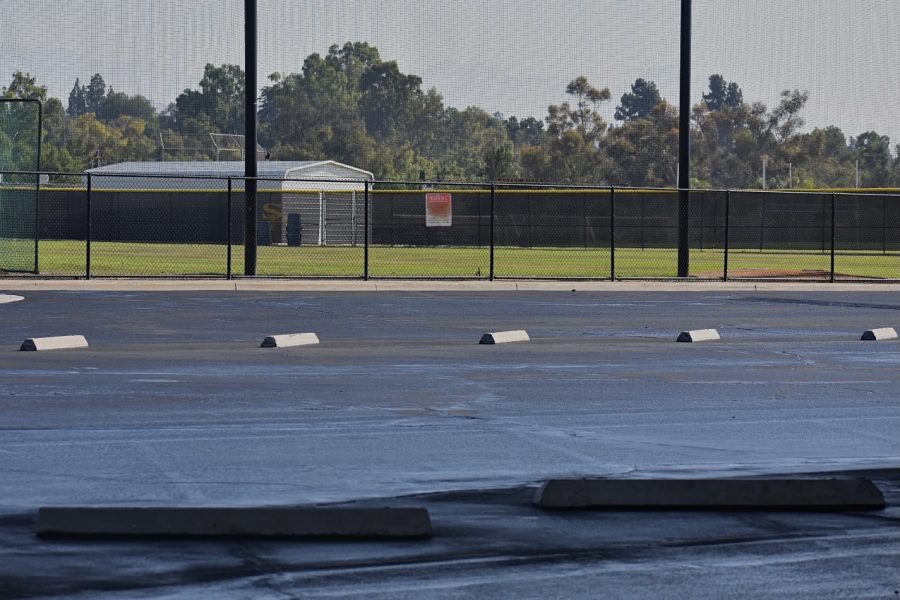 Workers reslurry and repaint the Sunny Hills High School parking lot next to the Performing Arts Center on Aug. 9 as the last step in finalizing its renovation. 