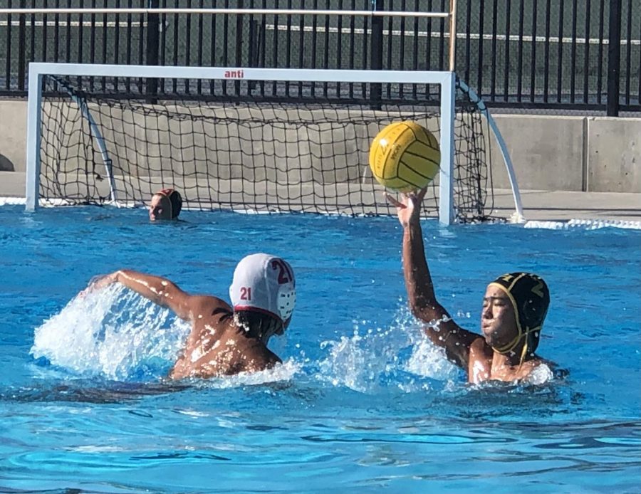 Utility+player+sophomore+Dylan+Loh+%28right%29+looks+to+pass+the+ball+to+a+teammate+while+fighting+off+a+Garden+Grove+High+School+defender+during+a+Tuesday%2C+Sept.+14%2C+home+game.
