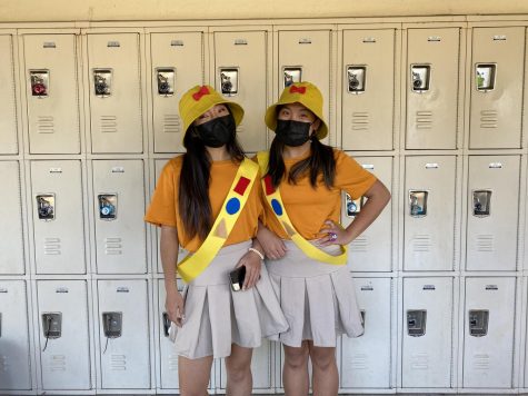 Junior Grace Min poses with junior Stacy Kim in their matching Halloween costumes as the Fireside Girls on Oct. 29.