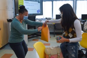 Math teacher Kari Morita collects senior Sharon Choi’s spare change for the Minute of Hope fundraiser held by the Associated Student Body on Wednesday. 