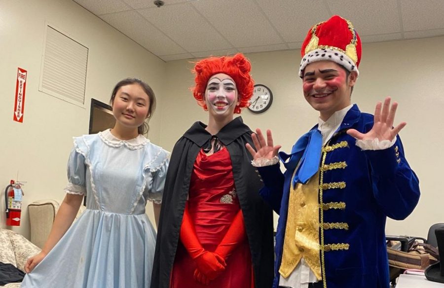 Sophomore Chloe Chun (left) as Alice joins junior Delaney Jackson as the Queen of Hearts and senior Zion Mejia as the King of Hearts in costume backstage during the video streaming production of “Alice.”