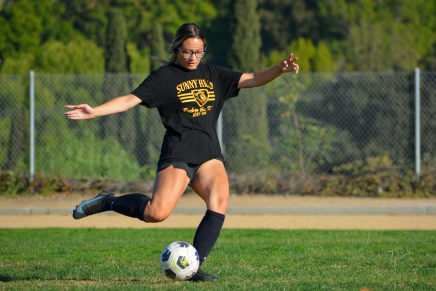 Girls soccer defender junior Kayla Pierce gets ready to knock the ball into the netting during a Nov. 15 goal kick drill at the Sunny Hills field.