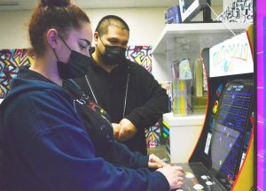 During new teacher Daniel Flores’ fourth period Video Production class in Room 136, junior Rylee Ortiz (left) plays a quick game of Pac-Man before the bell rings on Friday, Jan. 21. Flores arcade game is among the items he set up as part of the January theme about pop culture.