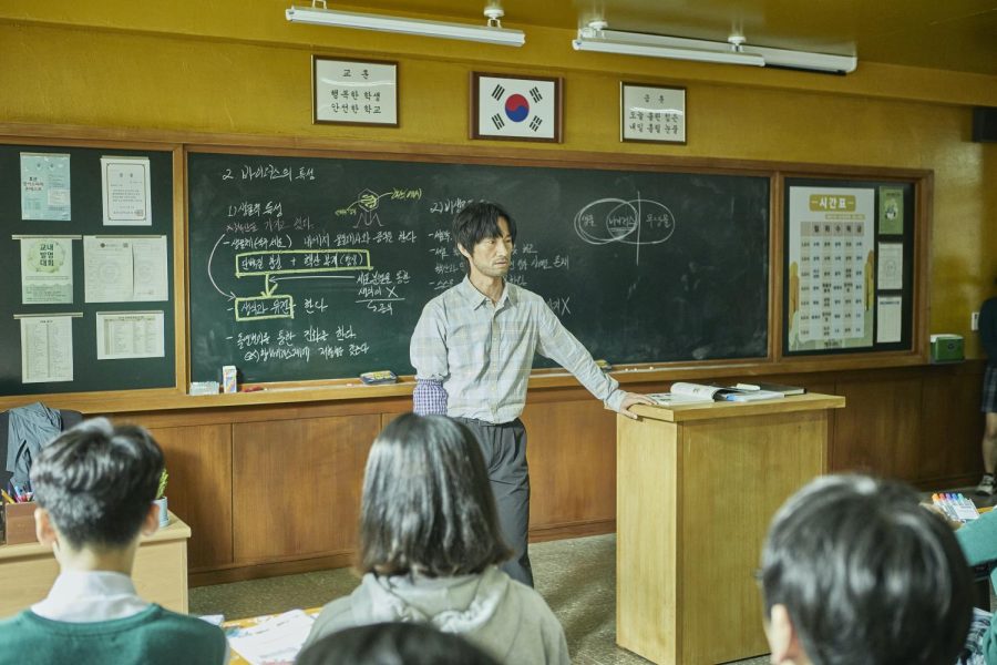 Hyosan High School science teacher Lee Byung Chan looks over his class only a few hours before the outbreak of a mysterious virus. 