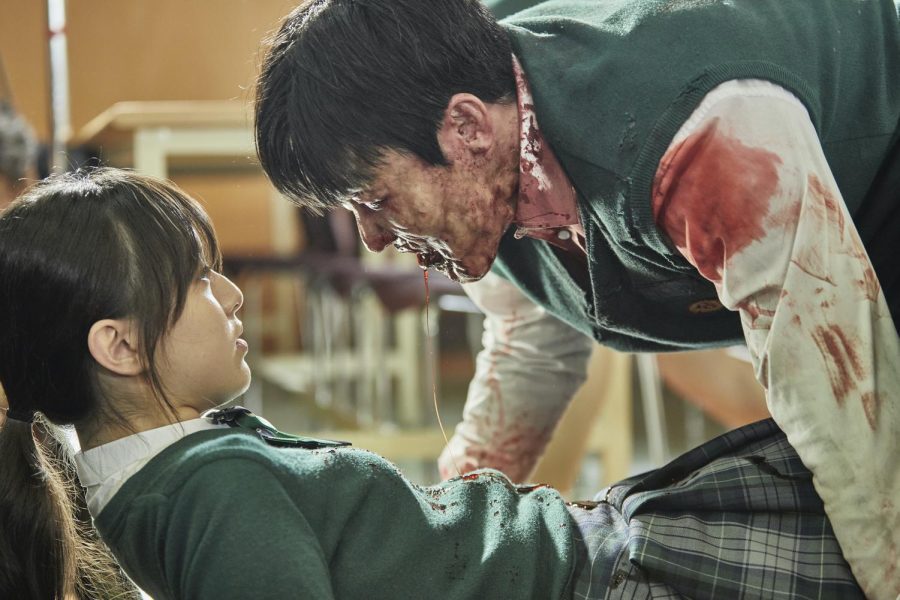 One of the protagonists played by Jihu Park, Nam On-jo (left), tries to escape from her first encounter with a zombie at her high school in Hyosan, South Korea, in Netflix's latest South Korean import following the highly successful 