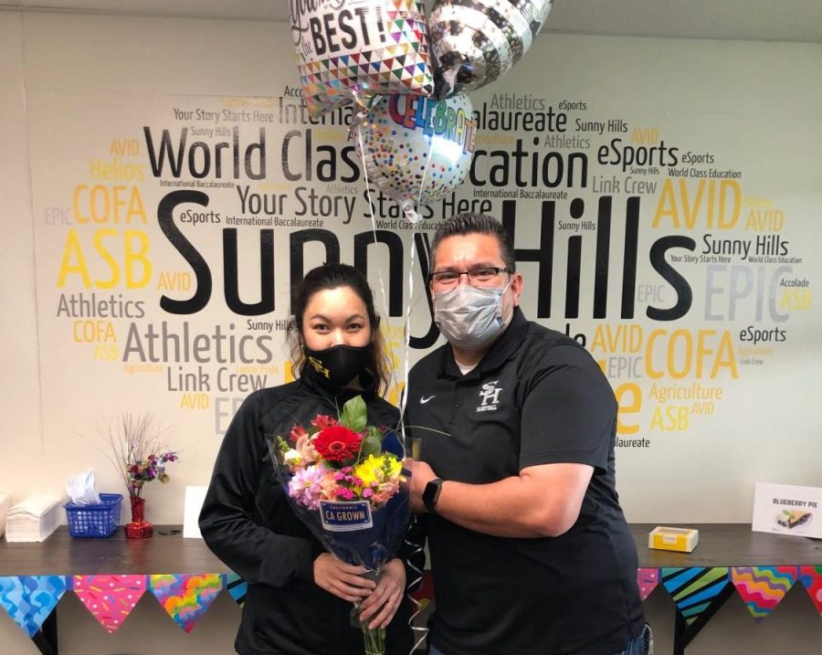 Student support services teacher Kellie Ma (left) and head custodian Daniel Rodriguez hold onto the flowers and balloons they were given in the staff lounge on Jan. 21 to recognize their honor of being voted Teacher of the Year and Classified Employee of the Year award, respectively, for the 2021-2022 school year. 