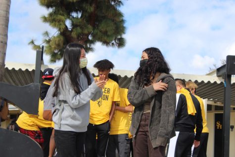 Wrestler junior Jenna Park (left), who qualified for Masters, applauds wrestler junior Kylie Yang, who qualified for State during a Feb. 22 rally on the Sunny Hills quad stage. Students and coaches gathered to celebrate the boys soccer team, boys basketball team and advancing wrestlers.
